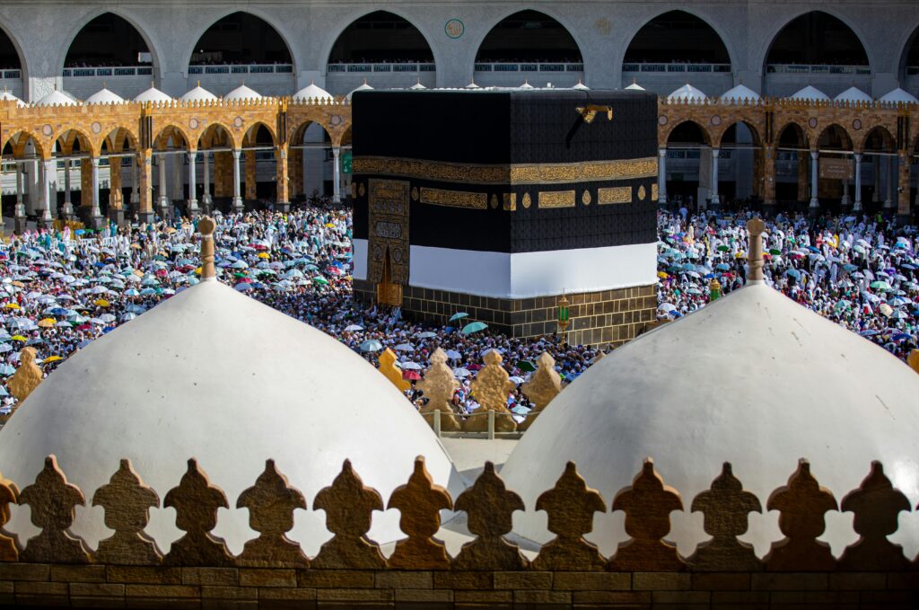 Crowds of pilgrims gather around the Kaaba in Mecca, Saudi Arabia during a religious event.