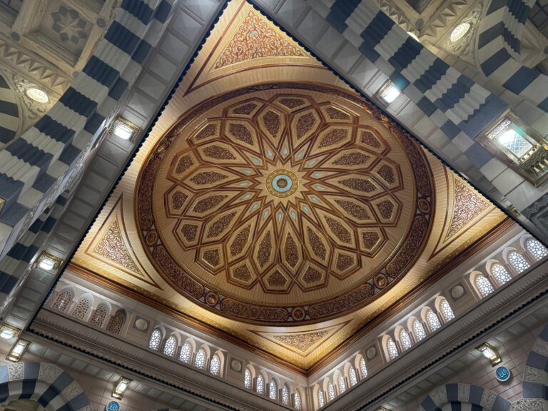 Umrah Detailed view of the ornate ceiling dome in a Medina mosque showcasing Islamic architecture.